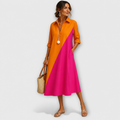 Woman wearing a two-tone orange and pink dress on a white background